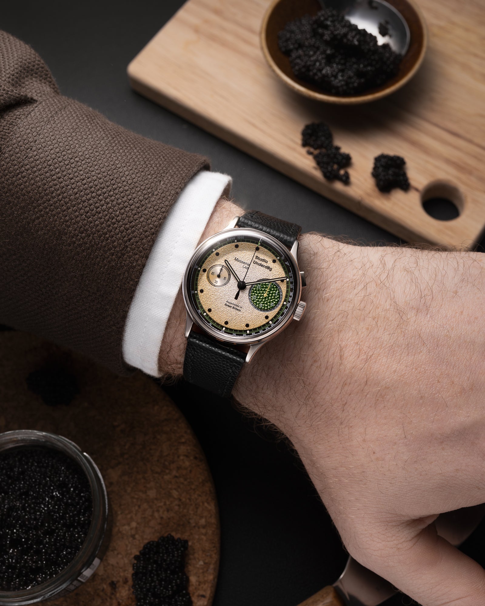 Studio Underd0g x Massena LAB Champagne & Caviar Monopusher Chronograph Limited Edition Wrist Shot worn with a brown over shirt, white cuff, with black caviar in the background