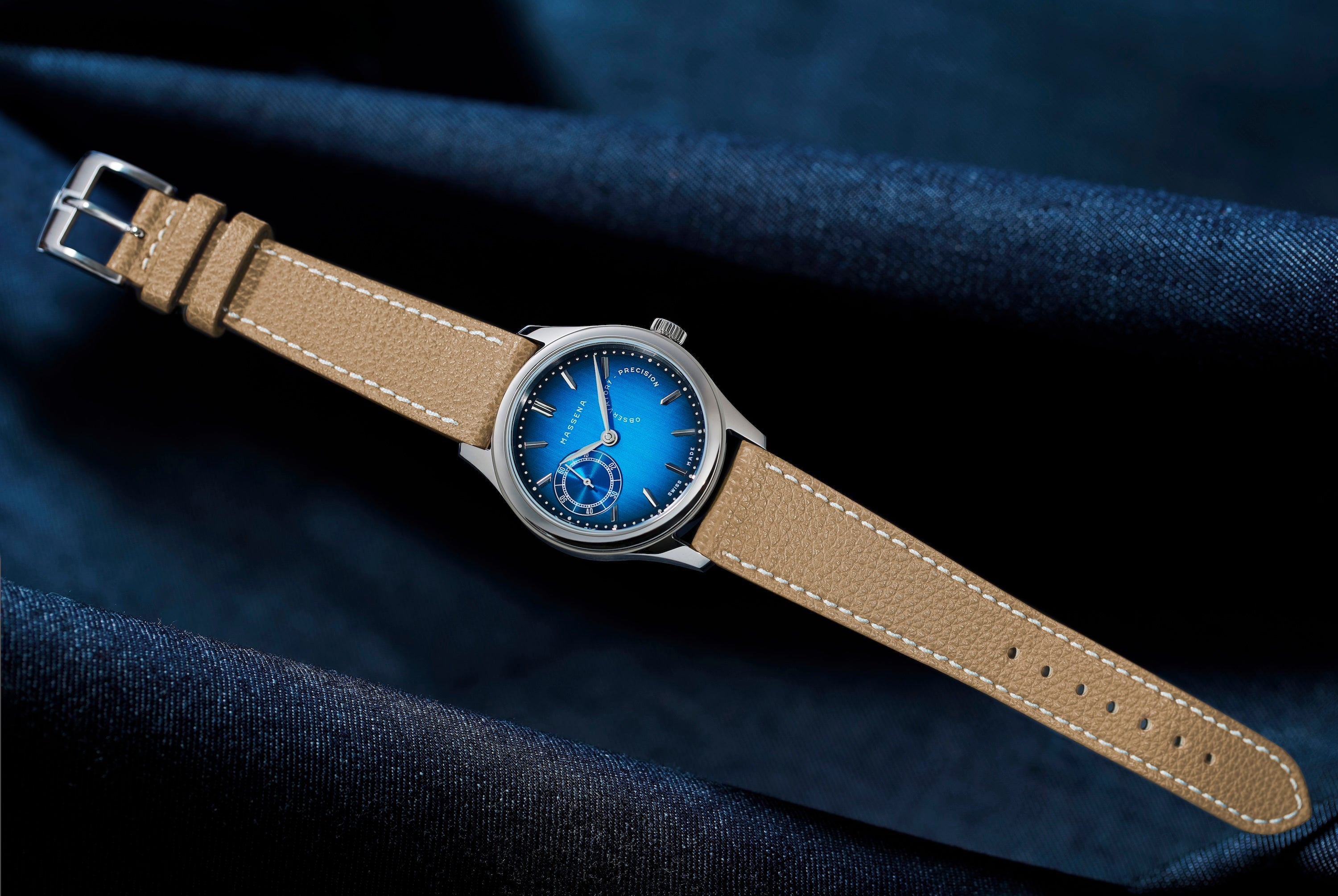 The TZ30 by Massena LAB and Raúl Pagès limited edition wristwatch shown on a dark blue denim background.